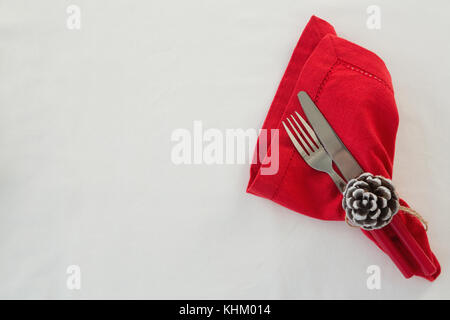 Close-up of fork, butter knife and pine cone tied with napkin Stock Photo