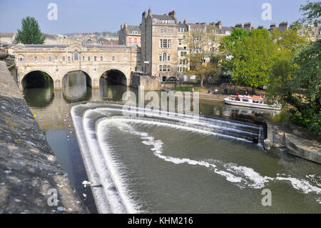 Pultney Weir and Bridge on the river Avon in the centre of Bath,with pleasure boat about to leave. Palladian Bridge  by Robert Adam, England, UK. Stock Photo