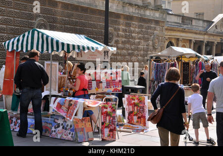 Street market stall selling bright pictures outside the Roman baths in Bath, Somerset,UK. Stock Photo