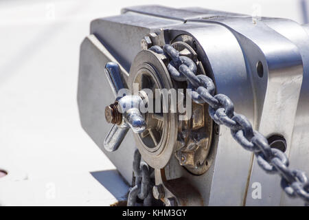 Anchor windlass mechanism with chain on ship deck Stock Photo