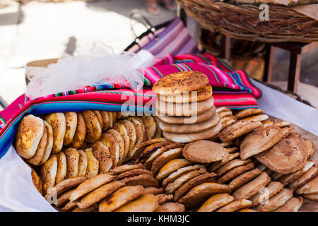 TARATA, COCHABAMBA, BOLIVIA S.A. - OCTOBER 2017: A baker sells bread (pan) along the quiet cobblestone roads of colonial Tarata, Bolivia. Stock Photo