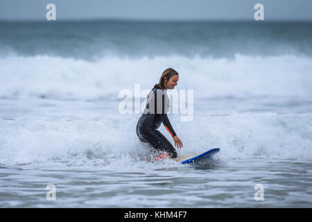 Young female surfing in Cornwall, england, UK Stock Photo