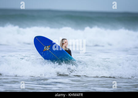 Young female surfing in Cornwall, england, UK Stock Photo