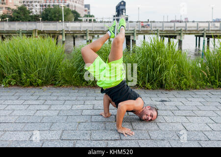 Young man break dancing in a park Stock Photo