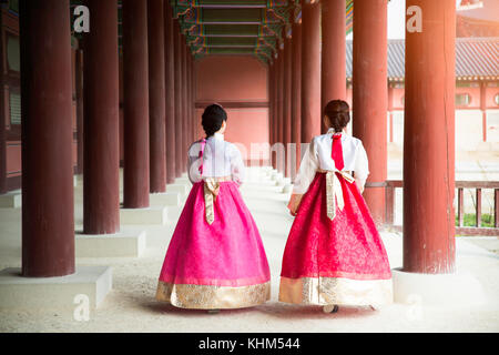 Asian Korean woman dressed Hanbok in traditional dress walking in Gyeongbokgung Palace in Seoul, South Korea. Stock Photo