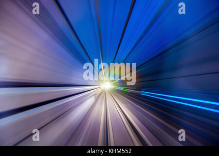 Speed blurred motion of train or subway train moving inside tunnel. Stock Photo