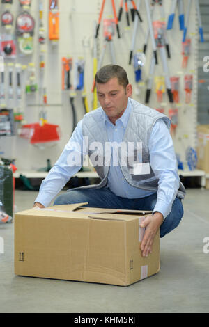porter carrying boxes in a warehouse Stock Photo