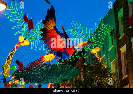 LONDON, UK - November 17th, 2017: Christmas lights on Carnaby Street; seasonal lights are being displayed over busy shopping area of central London. Stock Photo