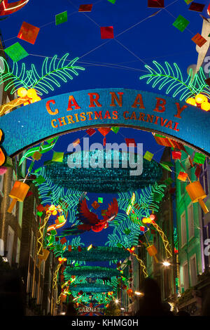 LONDON, UK - November 17th, 2017: Christmas lights on Carnaby Street; seasonal lights are being displayed over busy shopping area of central London. Stock Photo