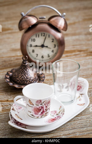 Turkish style coffee set served on a tray and an alarm clock Stock Photo