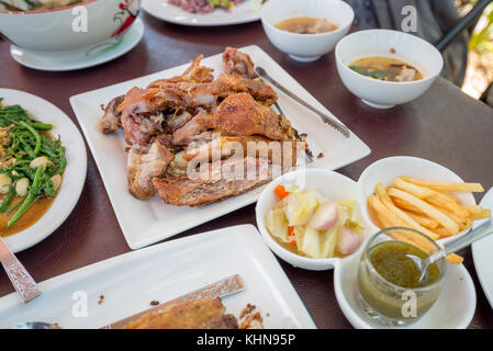 German Pork Hocks, Deep fried with French Fries and Appetizer by Thai Style Stock Photo