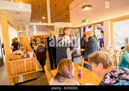 Staff and shoppers at the locally owned and managed Cletwr Cafe and community shop, Tre'r Ddol, Ceredigion Wales UK