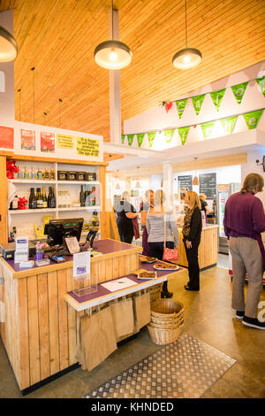 Staff and shoppers at the locally owned and managed Cletwr Cafe and community shop, Tre'r Ddol, Ceredigion Wales UK