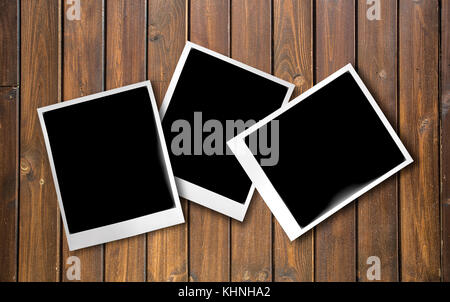 Blank instant photo frames on old wooden background. Stock Photo