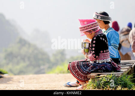 Back view of young girl hmong hill tribe in beautiful costume dress in Thailand. Stock Photo