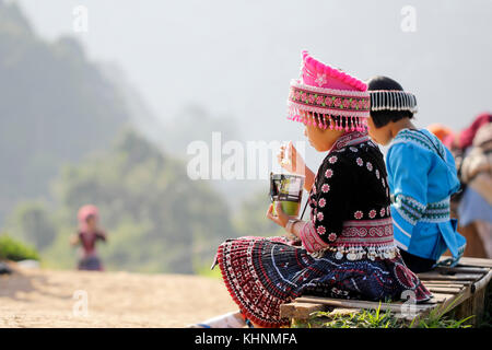 Back view of young girl hmong hill tribe in beautiful costume dress in Thailand. Stock Photo