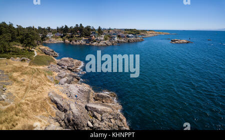 Aerial panoramic landscape view of a beautiful rocky shore on Pacific Coast. Taken in Saxe Point Park, Victoria, Vancouver Island, British Columbia, C Stock Photo