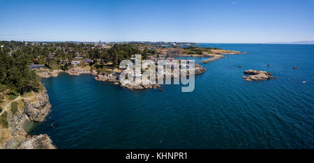 Aerial panoramic landscape view of a beautiful rocky shore on Pacific Coast. Taken in Saxe Point Park, Victoria, Vancouver Island, British Columbia, C Stock Photo