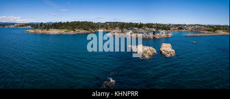 Aerial panoramic landscape view of a beautiful rocky shore on Pacific Coast. Taken in Saxe Point Park, Victoria, Vancouver Island, British Columbia, C Stock Photo