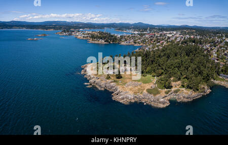 Aerial panoramic landscape view of a beautiful rocky shore on Pacific Coast. Taken in Saxe Point Park, Victoria, Vancouver Island, British Columbia, C Stock Photo