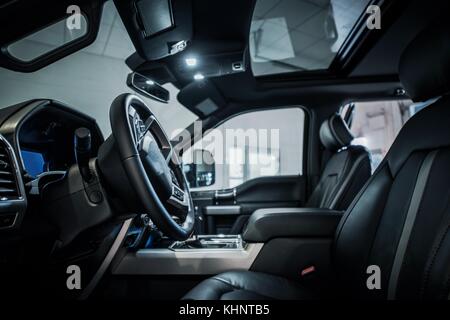 Modern Pickup Dark Interior. Spacious Truck Cabin. Stock Photo