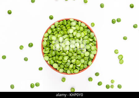 Dried split peas in a brown bowl on a white background Stock Photo