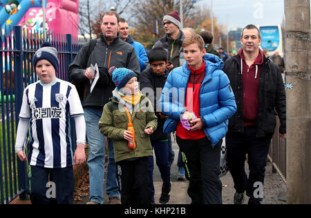 Fans make their way to the stadium prior to the Premier League match at The Hawthorns, West Bromwich. Stock Photo