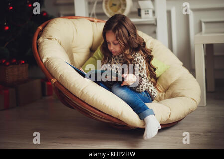 girl reads book sitting at home Stock Photo
