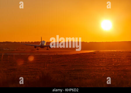 Airplane landing airport sun sunset vacation holidays travel traveling plane aircraft travelling Stock Photo