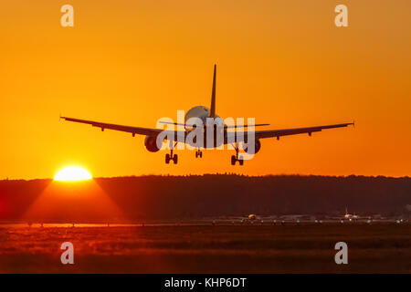 Airplane landing flying airport sun sunset vacation holidays travel traveling plane aircraft travelling Stock Photo