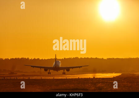 Vacation holidays travel airplane landing airport sun sunset plane aircraft travelling Stock Photo