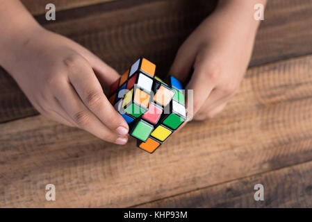 asian boy playing with rubik's cube.boy solving puzzle.brain teaser toy Stock Photo