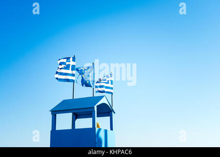 Greek Flag And EU Flag, Blue Sky And Viewpoint Hut In Blue Color In Palaria Katerini, Greece Stock Photo
