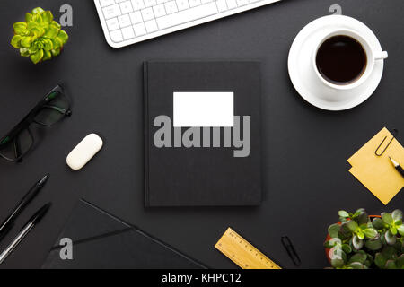 Folder With Label Surrounded By Office Supplies On Gray Desk Stock Photo
