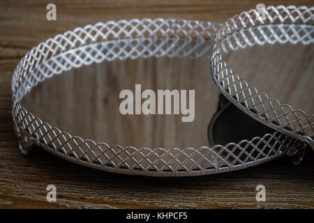 Classic style empty silver trays with mirror on brown wooden background Stock Photo