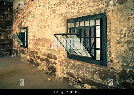 Rough stone interior wall with grunge window Stock Photo