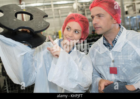 two busy engineers working together in factory Stock Photo