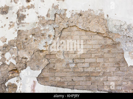 Falled plaster on brick wall Stock Photo