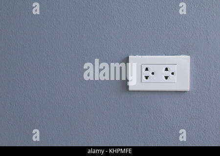 White electric plugs on blue wall background,White outlet interior, interior electric outlet in home,Socket electricity interior Stock Photo