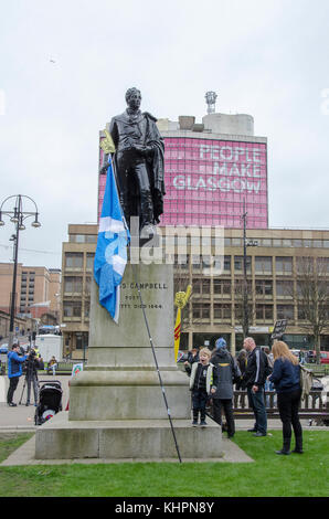 GLASGOW, SCOTLAND- APRIL 04 2015: A saltire leaning on the statue of Scots poet Thomas Campbell. Stock Photo