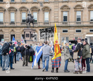 GLASGOW, SCOTLAND- APRIL 04 2015: A man holding an 'Our only threat is Westminster' banner at a Bairns Not Bombs Scrap Trident Demo at George Square Stock Photo