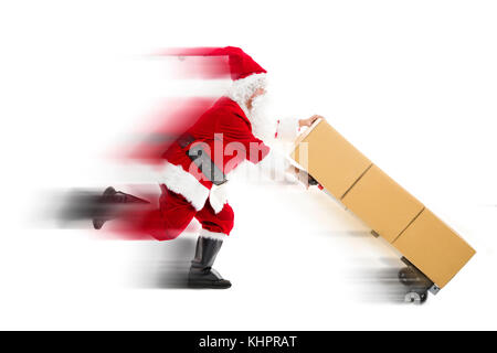 Santa Claus running and delivering Christmas presents Stock Photo