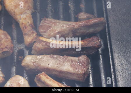 Grilling delicious variety of meat on barbecue grill Stock Photo