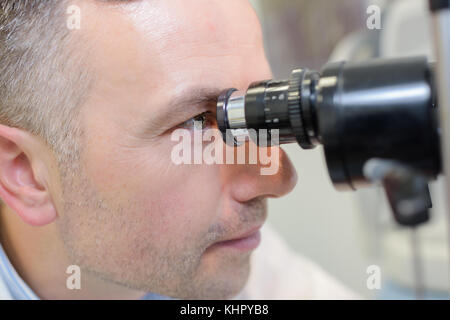 optometrist performing visual field test to little patient Stock Photo ...