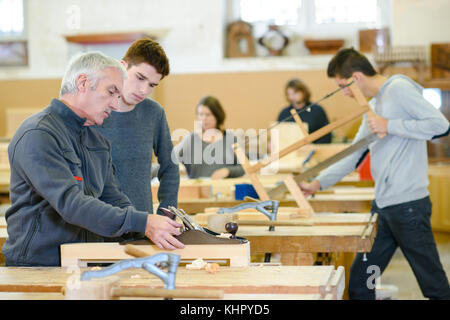 student and teacher in carpentry class Stock Photo
