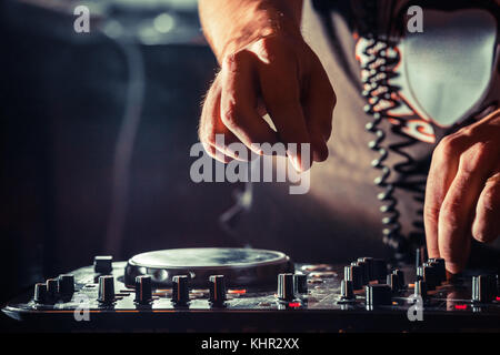 DJ playing music at mixer, hands closeup Stock Photo