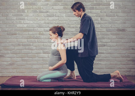 Traditional Thai Massage of a pregnant woman Stock Photo