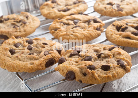 Delicious homemade chocolate chip cookies cooling on a rack. Stock Photo