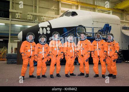 NASA International Space Station Space Shuttle Atlantis STS-122 mission prime crew members (L-R) German astronaut Hans Schlegel and French astronaut Leopold Eyharts from the European Space Agency, and American astronauts Stanley Love, Stephen Frick, Alan Poindexter, Leland Melvin and Rex Walhein wear orange launch and entry spacesuits during a pre-launch training session at the Johnson Space Center Space Vehicle Mockup Facility May 1, 2007 in Houston, Texas.  (photo by NASA Photo via Planetpix) Stock Photo