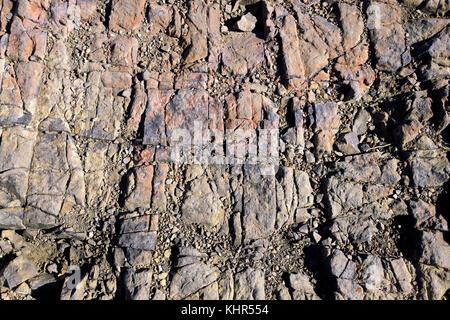 A rough red rock face texture. Stock Photo